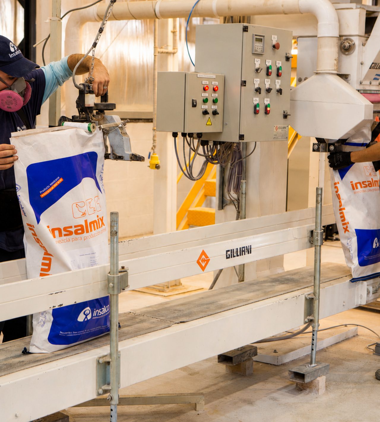 Operators bagging compound feed on a packing line
